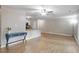 Bright living room with hardwood floors, fan, and easy access to the kitchen at 2010 Quaker Lndg # 102, Raleigh, NC 27603