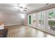 Inviting living room with hardwood floors, fan and sliding door to exterior space at 2010 Quaker Lndg # 102, Raleigh, NC 27603