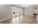 This bright living room features hardwood floors, a ceiling fan, and a sliding door to the exterior at 2010 Quaker Lndg # 102, Raleigh, NC 27603