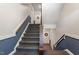 Carpeted stairwell with wooden handrail leads to upper-level apartments at 2010 Quaker Lndg # 102, Raleigh, NC 27603