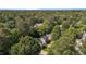 This home is surrounded by mature trees, offering a sense of privacy and natural beauty at 203 Kronos Lane, Cary, NC 27513