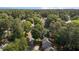 Aerial view showcasing the home's location, nestled among lush trees with convenient street access at 203 Kronos Lane, Cary, NC 27513