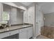 Bright primary bathroom with granite counters, tiled floor, walk-in shower, and large vanity at 203 Kronos Lane, Cary, NC 27513