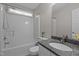Bathroom featuring a shower-tub combo and a granite vanity top at 203 Kronos Lane, Cary, NC 27513