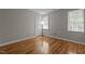 Cozy bedroom with wood floors, neutral walls, and a well-lit window at 203 Kronos Lane, Cary, NC 27513
