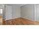 Neutral bedroom with wood floor and white door at 203 Kronos Lane, Cary, NC 27513