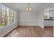 Traditional dining room featuring a large window and wood-look floors at 203 Kronos Lane, Cary, NC 27513
