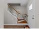 Inviting entryway featuring hardwood stairs and a white front door at 203 Kronos Lane, Cary, NC 27513