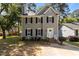 Two story home featuring black shutters, white trim, and manicured front yard at 203 Kronos Lane, Cary, NC 27513