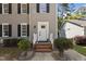 Classic home front entrance with sidelights, fresh paint and manicured bushes at 203 Kronos Lane, Cary, NC 27513