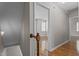 Second floor hallway shows view into bedroom with ample natural light and wood floors at 203 Kronos Lane, Cary, NC 27513