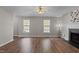 Open-concept living area with lots of light, wood floors, and a ceiling fan at 203 Kronos Lane, Cary, NC 27513