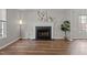 Bright and airy living room with a fireplace and wood-look flooring at 203 Kronos Lane, Cary, NC 27513