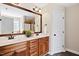 Bathroom featuring double sinks, framed mirrors, and warm wood-tone cabinets at 206 Wynngate Dr, Cameron, NC 28326