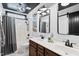 Modern bathroom with double vanity, black hardware, and tiled shower at 206 Wynngate Dr, Cameron, NC 28326