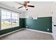 Cozy bedroom with split tone paint, ceiling fan, and natural light at 206 Wynngate Dr, Cameron, NC 28326