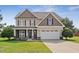 Charming two-story home with a well-maintained lawn, inviting entrance, and attached two-car garage at 206 Wynngate Dr, Cameron, NC 28326