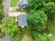 Aerial view of a home with mature trees, driveway, and lush green lawn in a quiet neighborhood at 21 Cedar Hill Dr, Durham, NC 27713