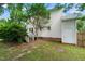 Spacious backyard with a lush lawn, mature trees, and a white-sided house, offering a serene outdoor space at 21 Cedar Hill Dr, Durham, NC 27713