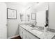 Bathroom with double sink vanity, granite countertops, and modern lighting fixtures at 21 Cedar Hill Dr, Durham, NC 27713