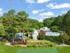 Beautiful community clubhouse and pool area overlooking the lake; playgrounds are also visible at 21 Cedar Hill Dr, Durham, NC 27713