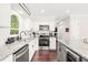 Bright kitchen with white cabinets, stainless steel appliances and granite countertops at 21 Cedar Hill Dr, Durham, NC 27713