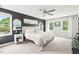 Spacious main bedroom featuring a ceiling fan, large windows, and elegant decor at 21 Cedar Hill Dr, Durham, NC 27713