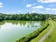 Picturesque pond with walking trail, surrounded by lush greenery, offering a tranquil outdoor experience at 21 Cedar Hill Dr, Durham, NC 27713