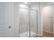 Tiled shower featuring sliding glass door and white fixtures at 2106 Cherry Creek Road Rd, Haw River, NC 27258
