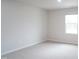 Bright bedroom with neutral carpet, light walls, and window, creating a serene and versatile space at 2106 Cherry Creek Road Rd, Haw River, NC 27258