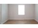 Bright bedroom featuring light wood floors, a window, and neutral wall paint at 2106 Cherry Creek Road Rd, Haw River, NC 27258