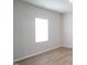 Bright bedroom featuring light wood floors, a window, and neutral wall paint at 2106 Cherry Creek Road Rd, Haw River, NC 27258