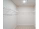 Spacious walk-in closet with ample shelving and neutral carpeting at 2106 Cherry Creek Road Rd, Haw River, NC 27258