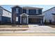 Charming two-story home with blue siding, open garage, and landscaped front yard at 2106 Cherry Creek Road Rd, Haw River, NC 27258