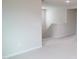 Upstairs hallway features neutral paint and carpeting leading to staircase at 2106 Cherry Creek Road Rd, Haw River, NC 27258