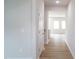 Bright hallway featuring light wood floors and white trim leading to the living areas at 2106 Cherry Creek Road Rd, Haw River, NC 27258