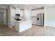 Modern kitchen features white cabinetry, stainless steel appliances, and center island at 2106 Cherry Creek Road Rd, Haw River, NC 27258