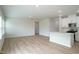 Open-concept living room featuring light wood floors and neutral walls adjoining kitchen at 2106 Cherry Creek Road Rd, Haw River, NC 27258