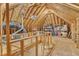 Unfinished attic featuring exposed wood beams, storage, and plywood flooring at 2125 Oakcrest Ct, Raleigh, NC 27612
