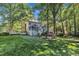 A large backyard with mature trees and a screened porch, perfect for outdoor living at 2125 Oakcrest Ct, Raleigh, NC 27612