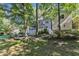 The house boasts a backyard with mature trees, a wooden deck, a screened porch and stairs at 2125 Oakcrest Ct, Raleigh, NC 27612