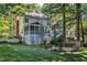Expansive backyard with screened porch, mature trees, and white picket fence at 2125 Oakcrest Ct, Raleigh, NC 27612