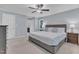 Bedroom featuring a ceiling fan, carpet and soft blue wall color at 2125 Oakcrest Ct, Raleigh, NC 27612