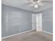 Light and airy bedroom with neutral walls and carpet featuring dual closets and a ceiling fan at 2125 Oakcrest Ct, Raleigh, NC 27612