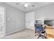 This bedroom features neutral walls, and carpet, dual closets, ceiling fan and desk with computer monitors at 2125 Oakcrest Ct, Raleigh, NC 27612