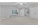 Large bedroom with an off-white carpet, dual closets, ceiling fan, and white desk by the window at 2125 Oakcrest Ct, Raleigh, NC 27612