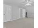 Bonus room with neutral carpet, and doors to access storage space at 2125 Oakcrest Ct, Raleigh, NC 27612