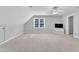 Spacious bonus room with neutral carpet, ceiling fan, and window with natural light at 2125 Oakcrest Ct, Raleigh, NC 27612