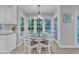 Bright eat-in kitchen with large windows, a breakfast table, and white cabinetry at 2125 Oakcrest Ct, Raleigh, NC 27612