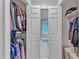 Walk-in closet featuring a window between rods and shelves at 2125 Oakcrest Ct, Raleigh, NC 27612